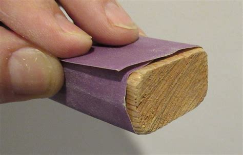 Sandpaper and sanding block on a model part