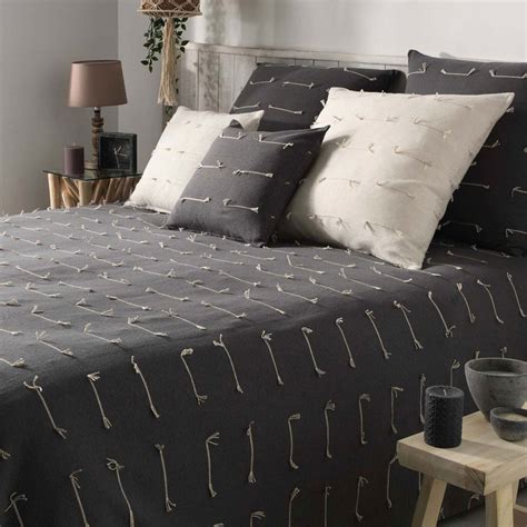 Une chambre avec un lit joliment décoré avec un couvre-lit